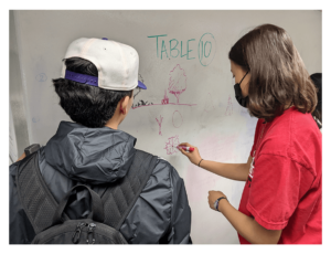 Experience UGA attendee and UGA CED student look at a drawing on a whiteboard