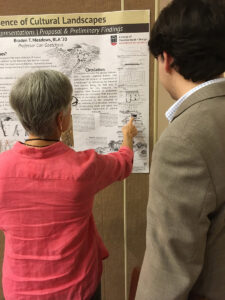 A woman points at Braden Meadows' poster.