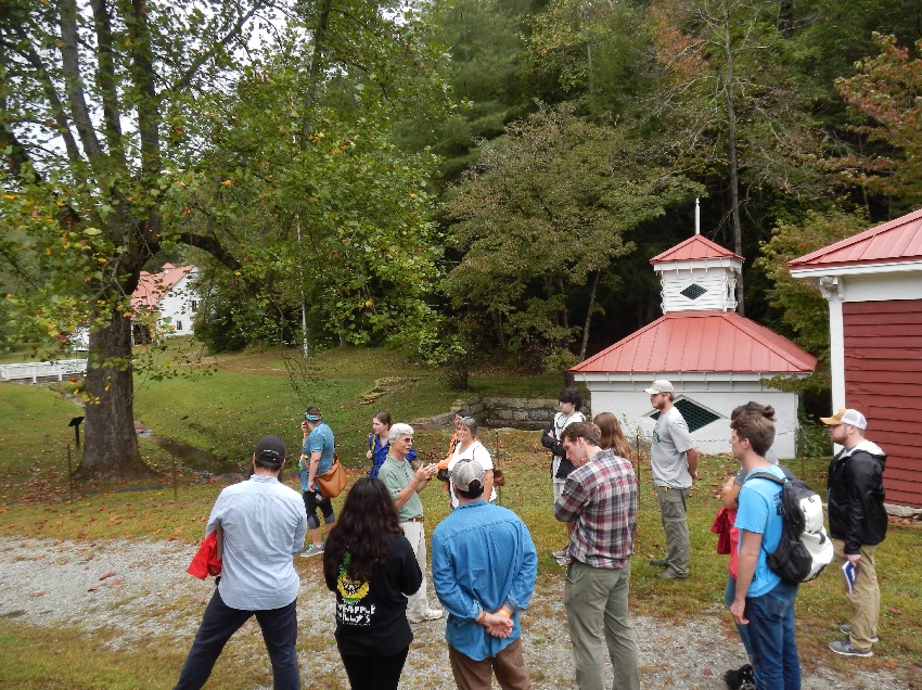 The group discusses the outbuildings and surrounding landscape at Hardman Farm.