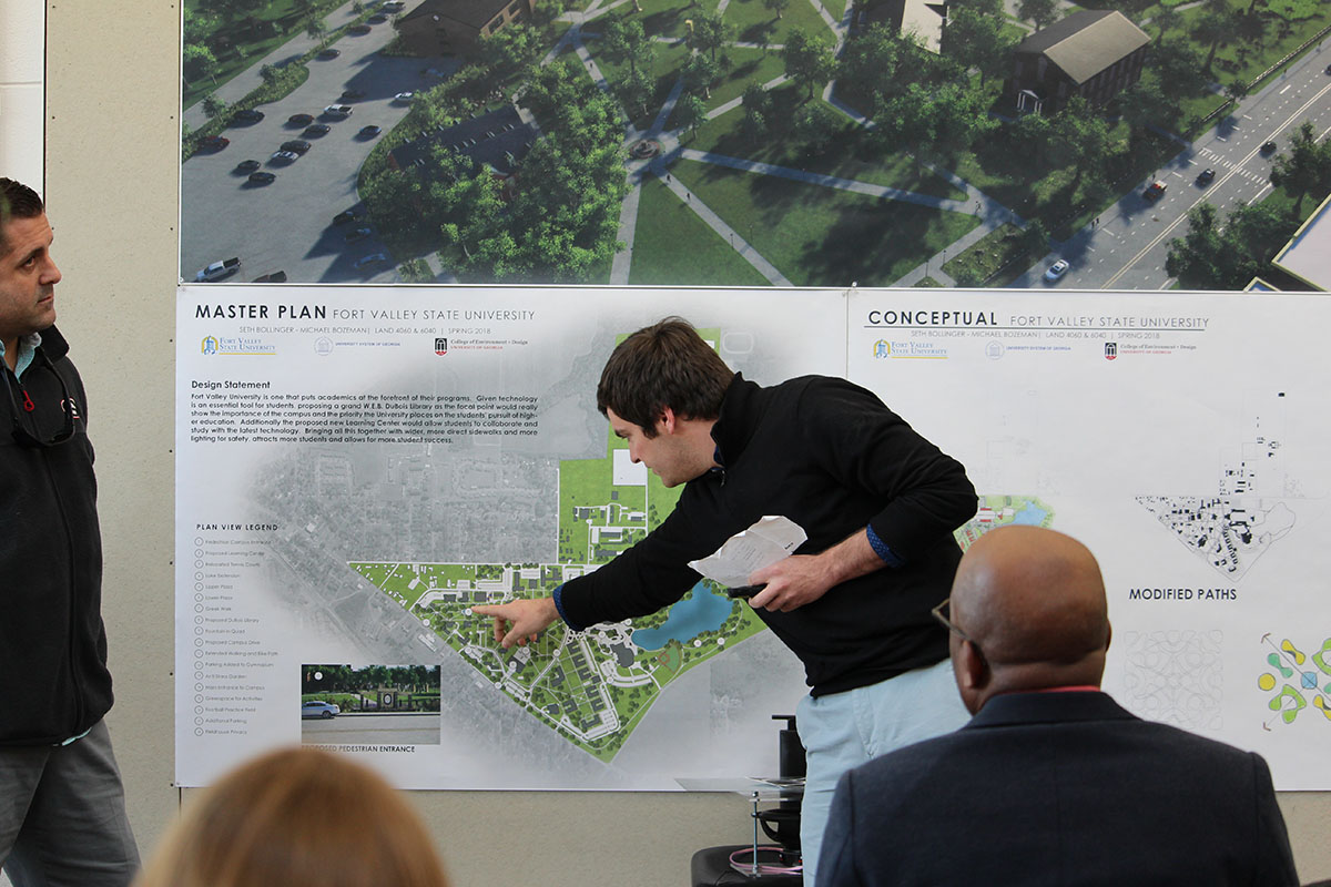 A man points at a Fort Valley State University master plan poster.