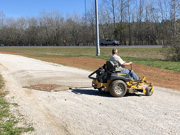 A man is on a tractor near The Ray work area.