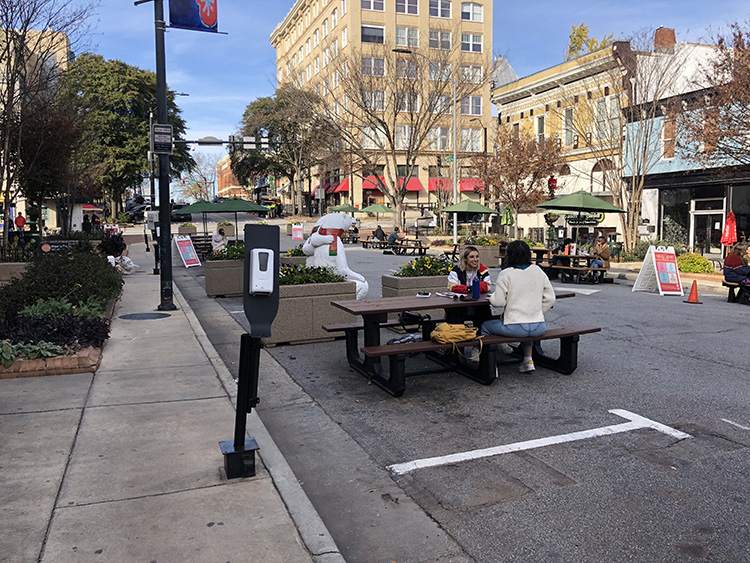College Square: Students using tables in College Square for studying and dining outdoors. 