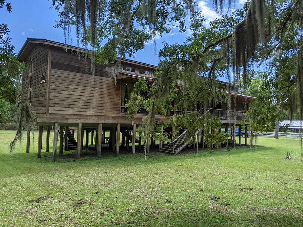 Exterior of a house built on stilts to prevent flooding.
