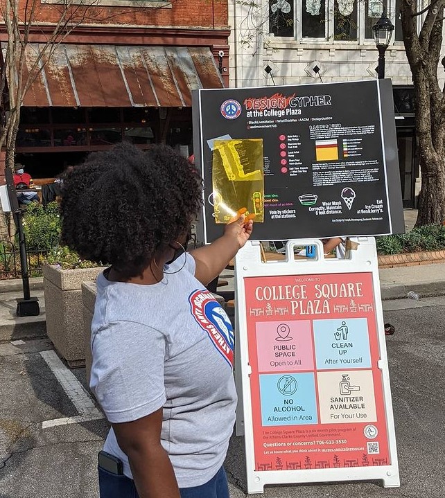 Whitney Barr leads a design cypher to engage passers-by in discussion for a racially inclusive plaza for College Square in downtown Athens. (Photo by Lynn Abdouni)