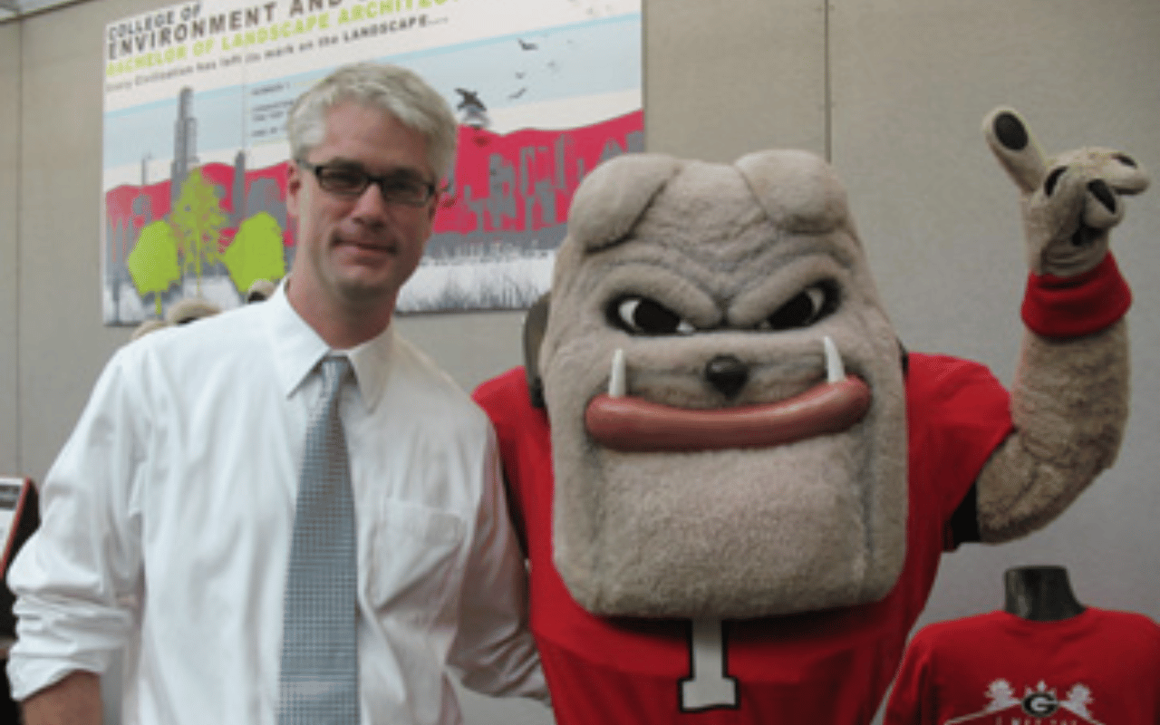 A picture of David Spooner with the UGA Hairy Dawg.