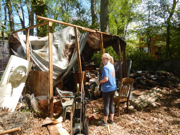 Olivia Head works to take down one of the temporary wooden structures in the backyard.