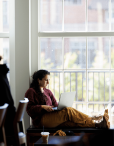 Undergraduate student Isabella Provenzano works at her laptop between classes at the Casey Commons in Amos Hall.