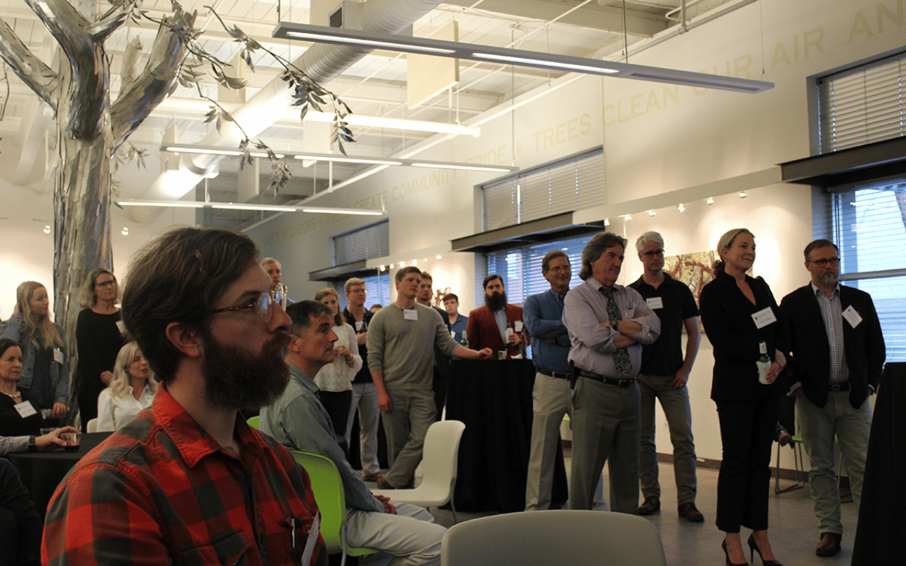 A group listens to a UGA CED speaker at the Trees Atlanta Annual Alumni Social in 2018.