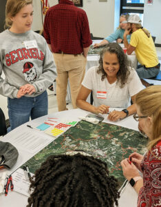 Participants gathered around a large map during a design charrette.