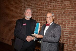 Crowley holding his award. 