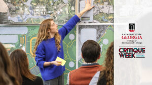 CED student presenting their site plans. Plans are pinned to the wall.